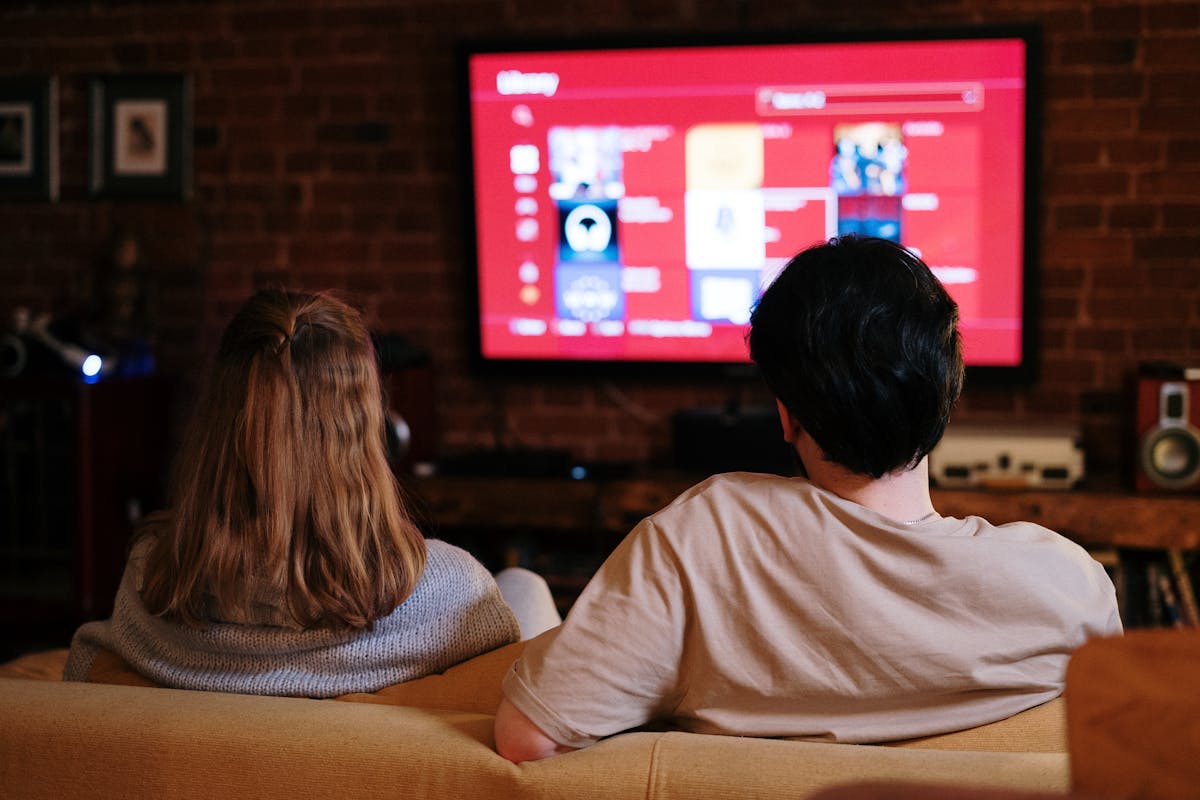 Couple watching TV in cozy living room